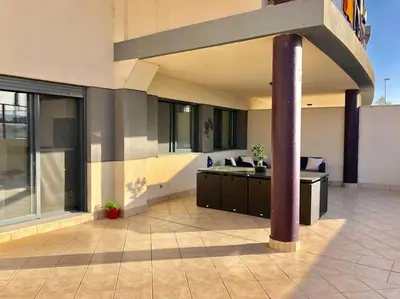 a large building with a pillar in a courtyard at Lujoso apartamento de dos habitaciones en la playa de Canet in Canet de Berenguer