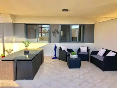 a living room with two couches and a table at Lujoso apartamento de dos habitaciones en la playa de Canet in Canet de Berenguer