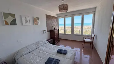 a bedroom with a bed with a view of the ocean at Primera línea de playa in Valencia