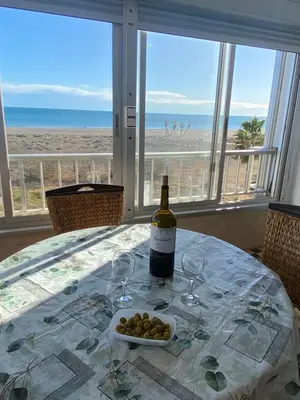 a bedroom with two beds and a nightstand and pictures on the wall at Primera línea de playa in Valencia
