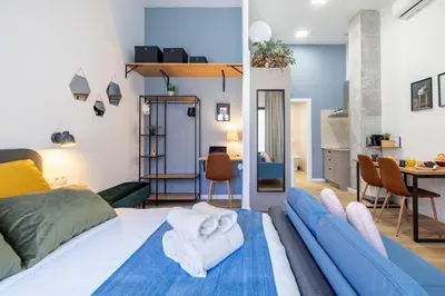 a bedroom with a bed and a living room at Travel Habitat Patraix Suite con Terracita in Valencia