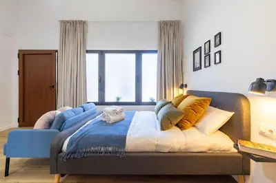 a bedroom with a bed and a blue couch at Travel Habitat Patraix Suite con Terracita in Valencia