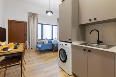 a kitchen and living room with a sink and a washing machine at Travel Habitat Patraix Suite con Terracita in Valencia