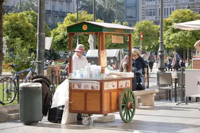 a food cart with a woman standing next to it at Travel Habitat Patraix Suite con Terracita in Valencia