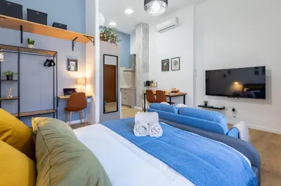 a living room with a large bed and a flat screen tv at Travel Habitat Patraix Suite con Terracita in Valencia