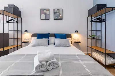 a bedroom with a large bed with towels on it at Travel Habitat Sant Isidre Suite in Valencia