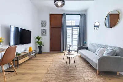 a living room with a couch and a tv at Travel Habitat Sant Isidre Suite in Valencia