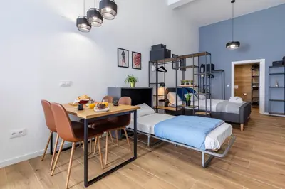 a room with a table and a bunk bed and a bedroom at Travel Habitat Sant Isidre Suite in Valencia