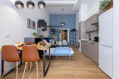 a kitchen and dining room with a table and chairs at Travel Habitat Sant Isidre Suite in Valencia