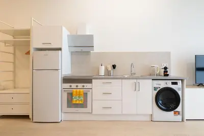 a kitchen with a white refrigerator and a dishwasher at NEW BEACH flats VALENCIA in Valencia