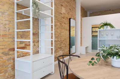 a room with a white book shelf and a table at NEW BEACH flats VALENCIA in Valencia