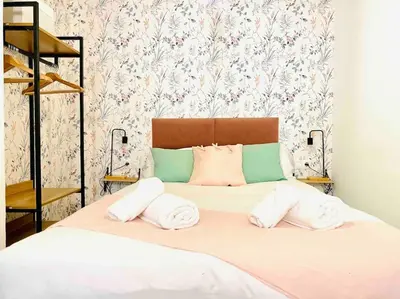 a bed with two pillows on top of it at Beautiful LOFT in the HEART of Ruzafa, SOHO in Valencia