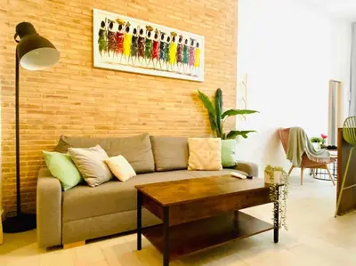 a living room with a couch and a table at Beautiful LOFT in the HEART of Ruzafa, SOHO in Valencia