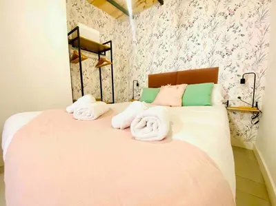 a bedroom with a large bed with towels on it at Beautiful LOFT in the HEART of Ruzafa, SOHO in Valencia