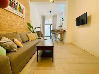 a living room with a couch and a table at Beautiful LOFT in the HEART of Ruzafa, SOHO in Valencia