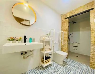 a bathroom with a sink and a toilet and a mirror at Beautiful LOFT in the HEART of Ruzafa, SOHO in Valencia