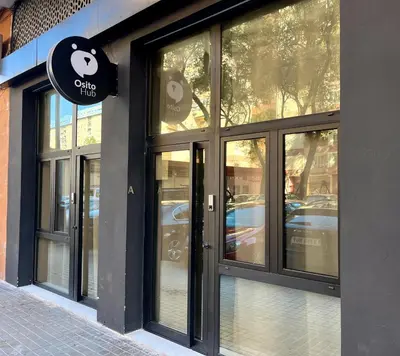 a store front with glass doors on a street at Osito Hub - Poeta Durán in Valencia