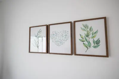 three framed prints of flowers and hearts on a wall at Cruz Cubierta Apartments in Valencia