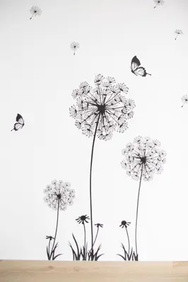 a group of dandelions with butterflies on a wall at Congresos Flat by Concept Flats in Valencia