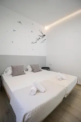 a bedroom with a large white bed with towels on it at Congresos Flat by Concept Flats in Valencia