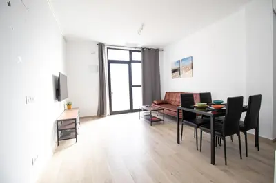 a living room with a table and a couch at Congresos Flat by Concept Flats in Valencia