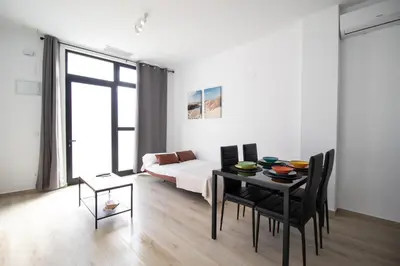 a living room with a table and a bed at Congresos Flat by Concept Flats in Valencia