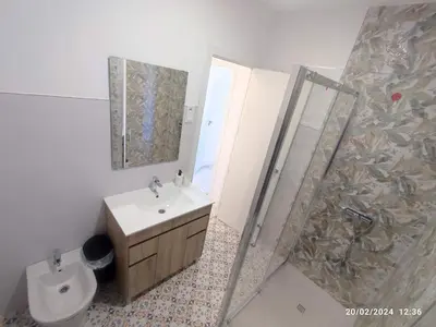 a bathroom with a toilet and a sink and a shower at Central Rooms - Valencia City Centre Boho-Cozy Downtown - VLC Urban Rental in Valencia