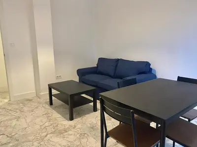 a living room with a blue couch and a table at Central Rooms - Valencia City Centre Boho-Cozy Downtown - VLC Urban Rental in Valencia