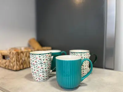 three blue and white cups sitting on a table at Central Rooms - Valencia City Centre Boho-Cozy Downtown - VLC Urban Rental in Valencia