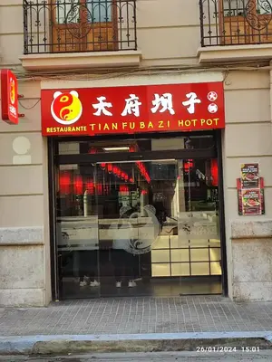 a store with a red sign on the front of a building at Central Rooms - Valencia City Centre Boho-Cozy Downtown - VLC Urban Rental in Valencia