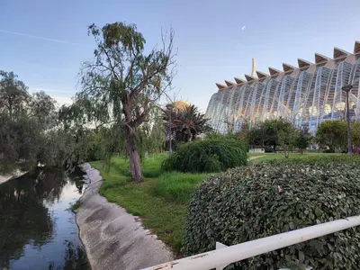 a river with a building in the background next to a building at Central Rooms - Valencia City Centre Boho-Cozy Downtown - VLC Urban Rental in Valencia