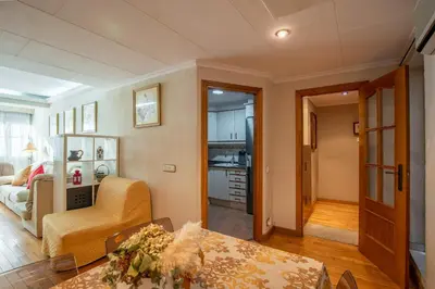 a living room with a couch and a table at La casa de Lili acerca de palacio de música in Valencia