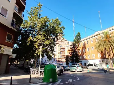 a street with cars parked in a parking lot at lifecoliving valencia loft A in Valencia