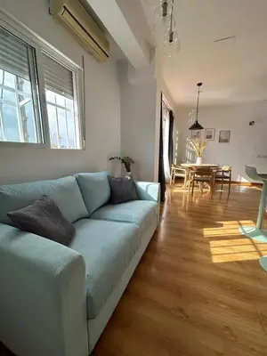 a living room with a blue couch and a table at SingularStays Valero III in Valencia