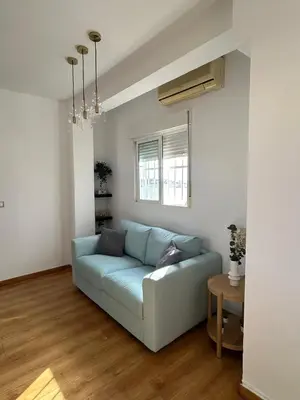 a living room with a blue couch and a table at SingularStays Valero III in Valencia