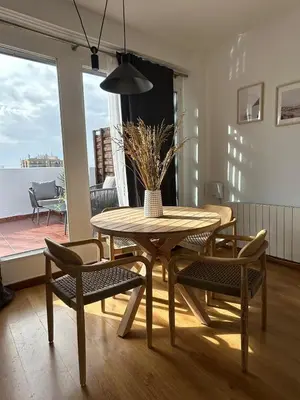 a dining room with a table and chairs and a window at SingularStays Valero III in Valencia