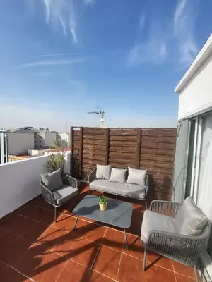 a patio with two couches and a table on a balcony at SingularStays Valero III in Valencia