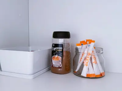 a bottle of coffee and a container of utensils at Studio Aiora in Valencia