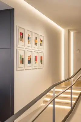a staircase in a building with paintings on the wall at Mon Suites Jardín de Ayora in Valencia