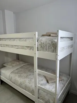 two white bunk beds in a room at UIM Mediterraneo Cendoya 2 Wifi in Puerto de Sagunto