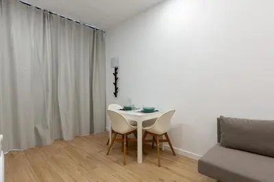 a dining room with a white table and chairs at Nuevo loft en playa y cerca del centro, AC y Wifi in Valencia