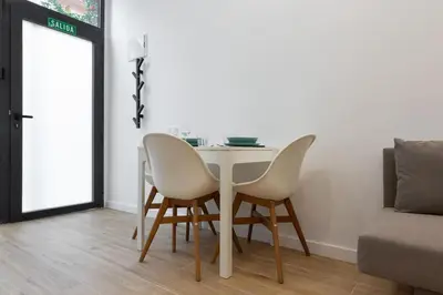 a dining room table with two chairs and a couch at Nuevo loft en playa y cerca del centro, AC y Wifi in Valencia