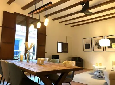 a dining room with a wooden table and chairs at Loft con estilo y terraza en centro histórico in Valencia