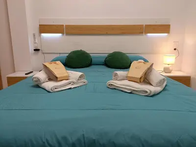a blue bed with two green spheres on top of it at Precioso Loft Sorolla en Playa Malvarrosa/Patacona in Valencia
