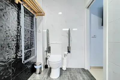 a bathroom with a toilet and a black and white wall at Precioso Loft Sorolla en Playa Malvarrosa/Patacona in Valencia