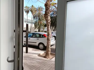 a white car parked on a street with a palm tree at Precioso Loft Sorolla en Playa Malvarrosa/Patacona in Valencia