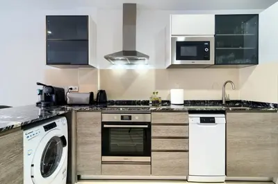a kitchen with a washing machine and a washer at Precioso Loft Sorolla en Playa Malvarrosa/Patacona in Valencia