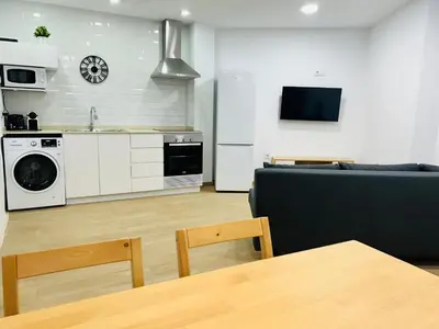 a kitchen and living room with a couch and a table at Patraix nice suite in Valencia