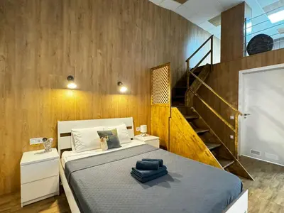 a bedroom with a large bed and a staircase at Lliri 7 in Valencia