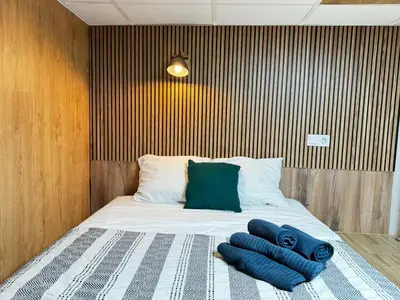a bed with two blue towels on top of it at Lliri 7 in Valencia